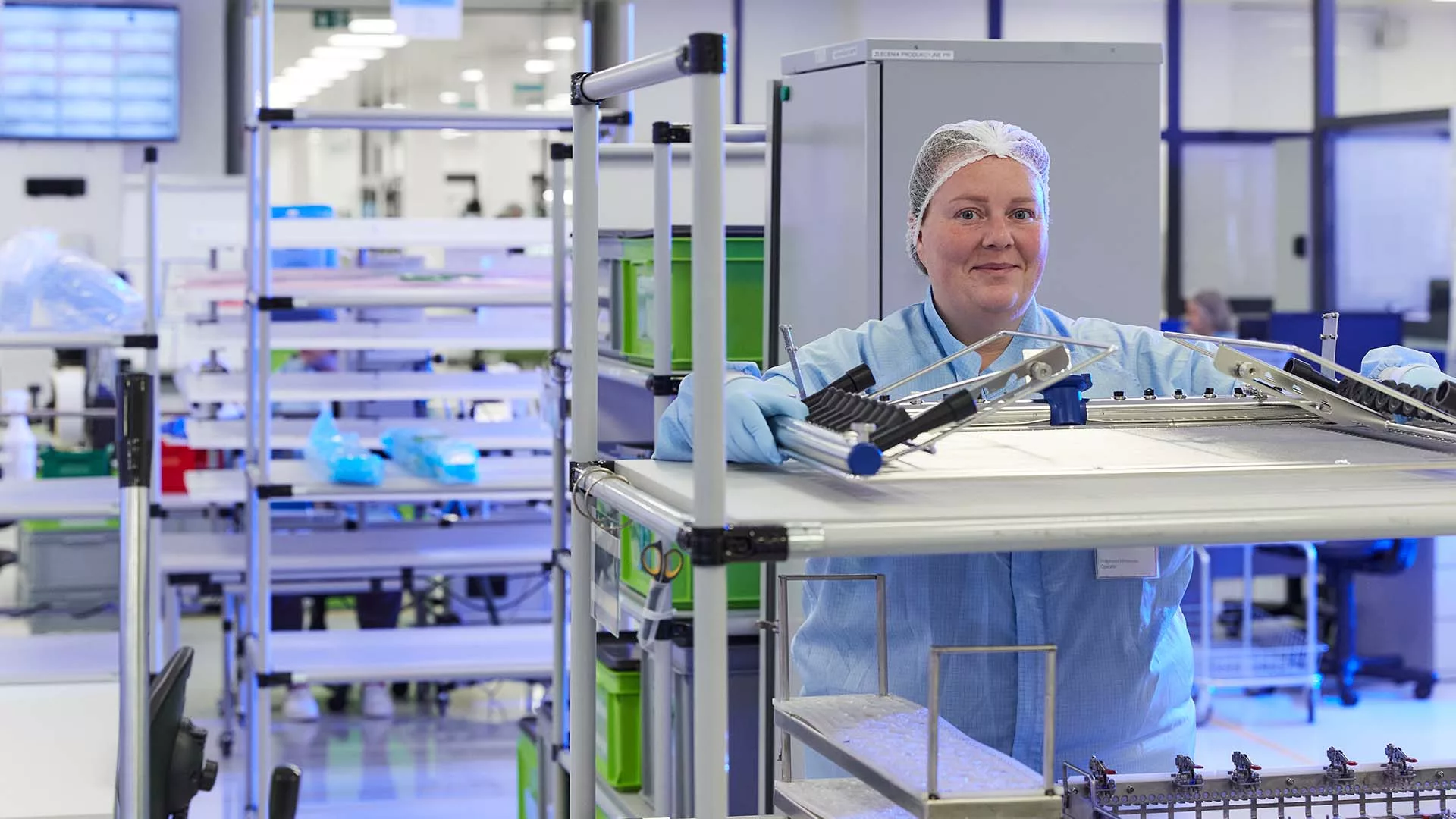 Woman smiling inside the Ensera sterilized medical packing facility.